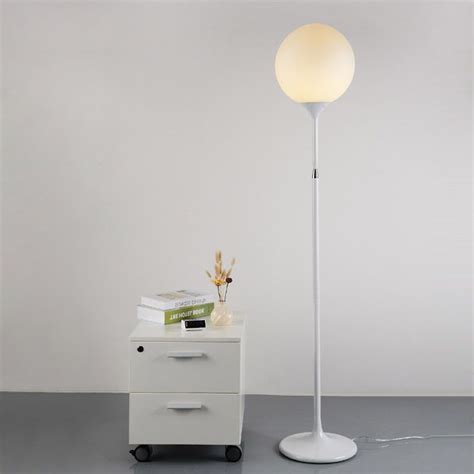 standing floor lamp with round globe and glass lampshade